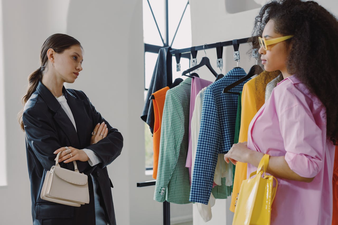 home-hero Two women browsing colorful clothing racks in a modern boutique.
